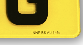 Close-up of the British Standard marking printed on the plate: NNP BS AU 145e